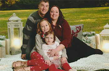 The Cline family seated together outdoors