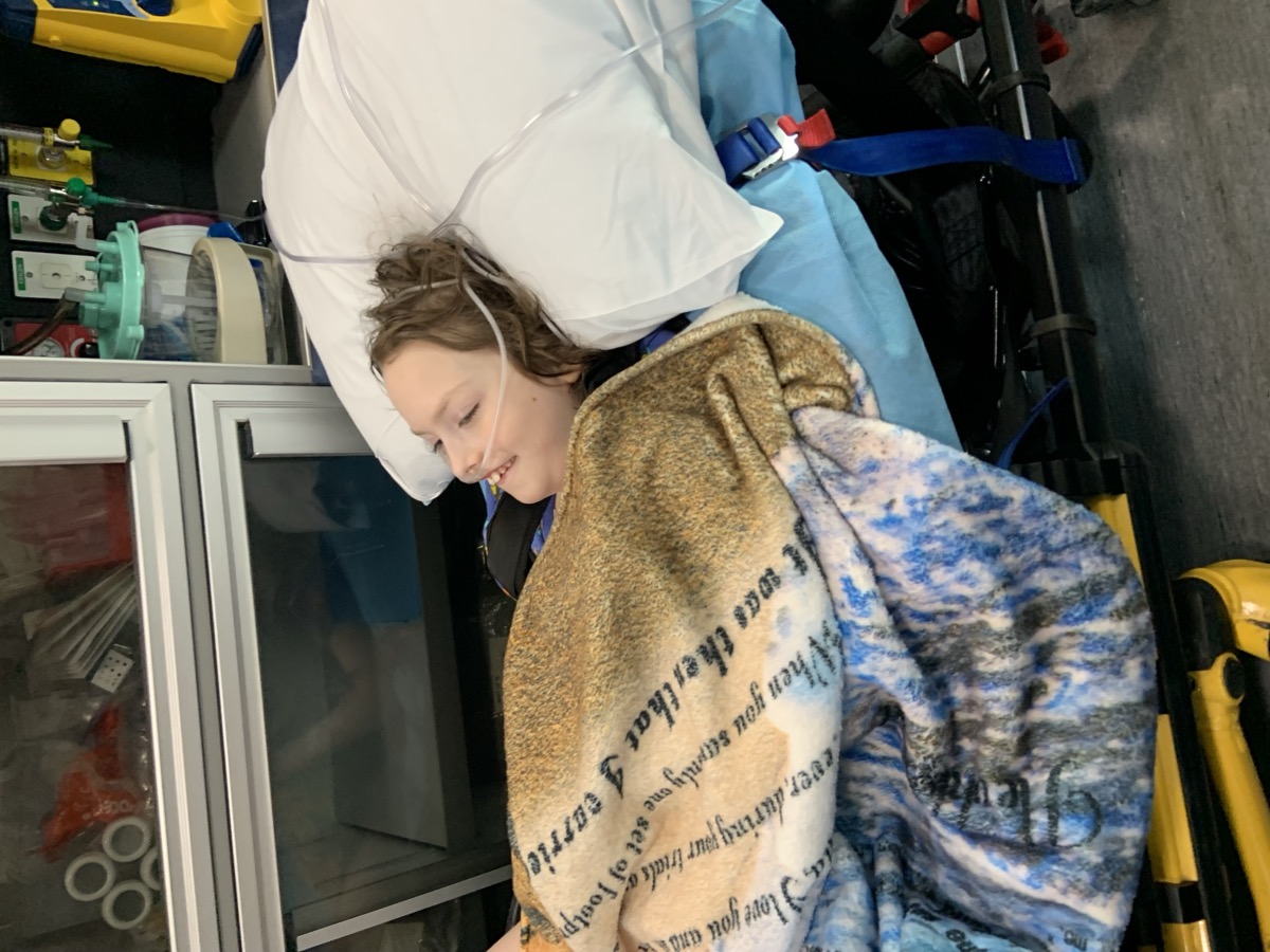 Sophia smiling during hospital transport in 2023