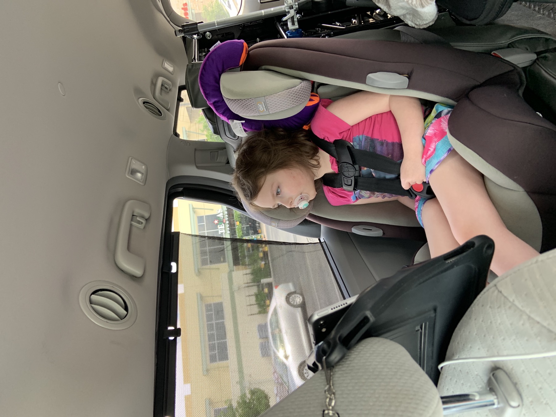 Sophia riding in a vehicle with medical equipment nearby